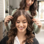 a happy girl showing her hair in women salon salon Oakville