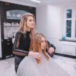 A girl is showing hair in women salon of Oakville