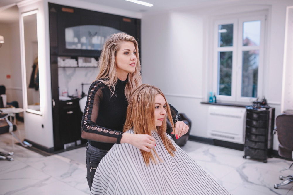 A girl is showing hair in women salon of Oakville