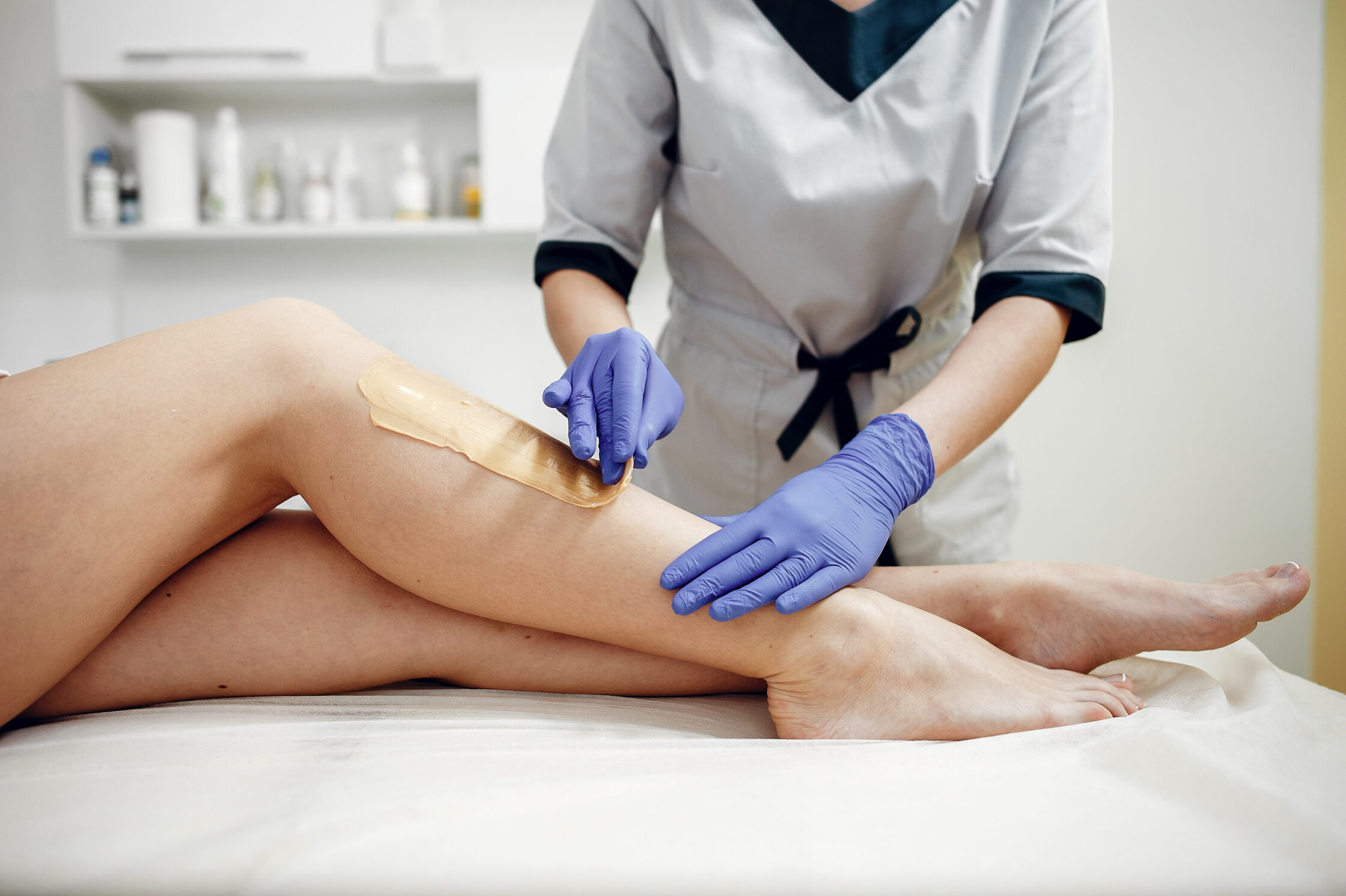 Beautiful young girl doing waxing in women salon