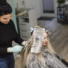 Blonde girl getting her hair done in women hair salon Oakville